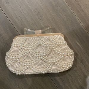 Charming Charlie’s pearl clutch with bow tie clasp